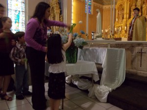 Presenting flowers to Mary