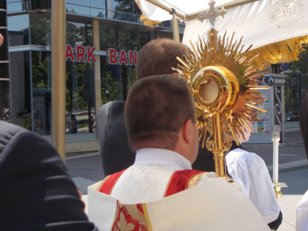 2012 Madison Corpus Christi Procession: Deacon Vince Brewer carries the Monstrance with Jesus from St Patrick's Church, toward Capitol Square.