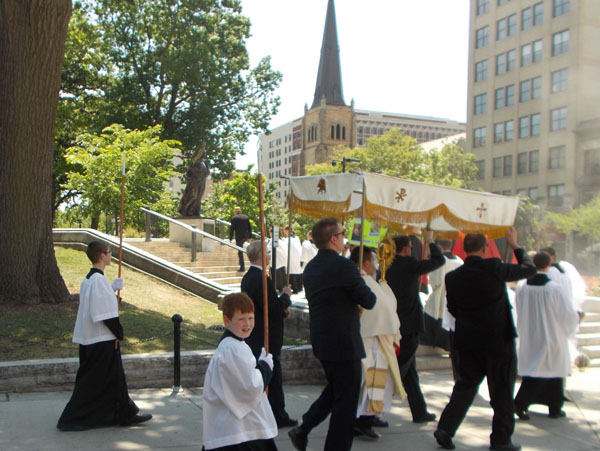 2012 Madison Corpus Christi Procession approaches the State Street Steps of the Capitol, precisely where the "Recall Walker" protests had been centered. In the background, the steeple of Grace Episcopal Church.