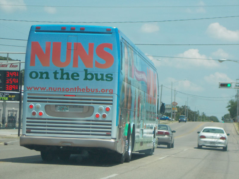 Nuns on the Bus stopped at a red light.