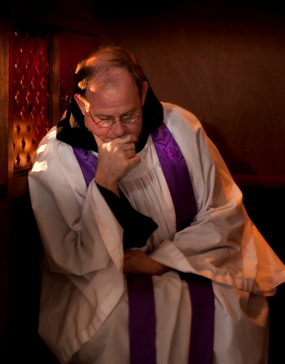 Priest in Confessional